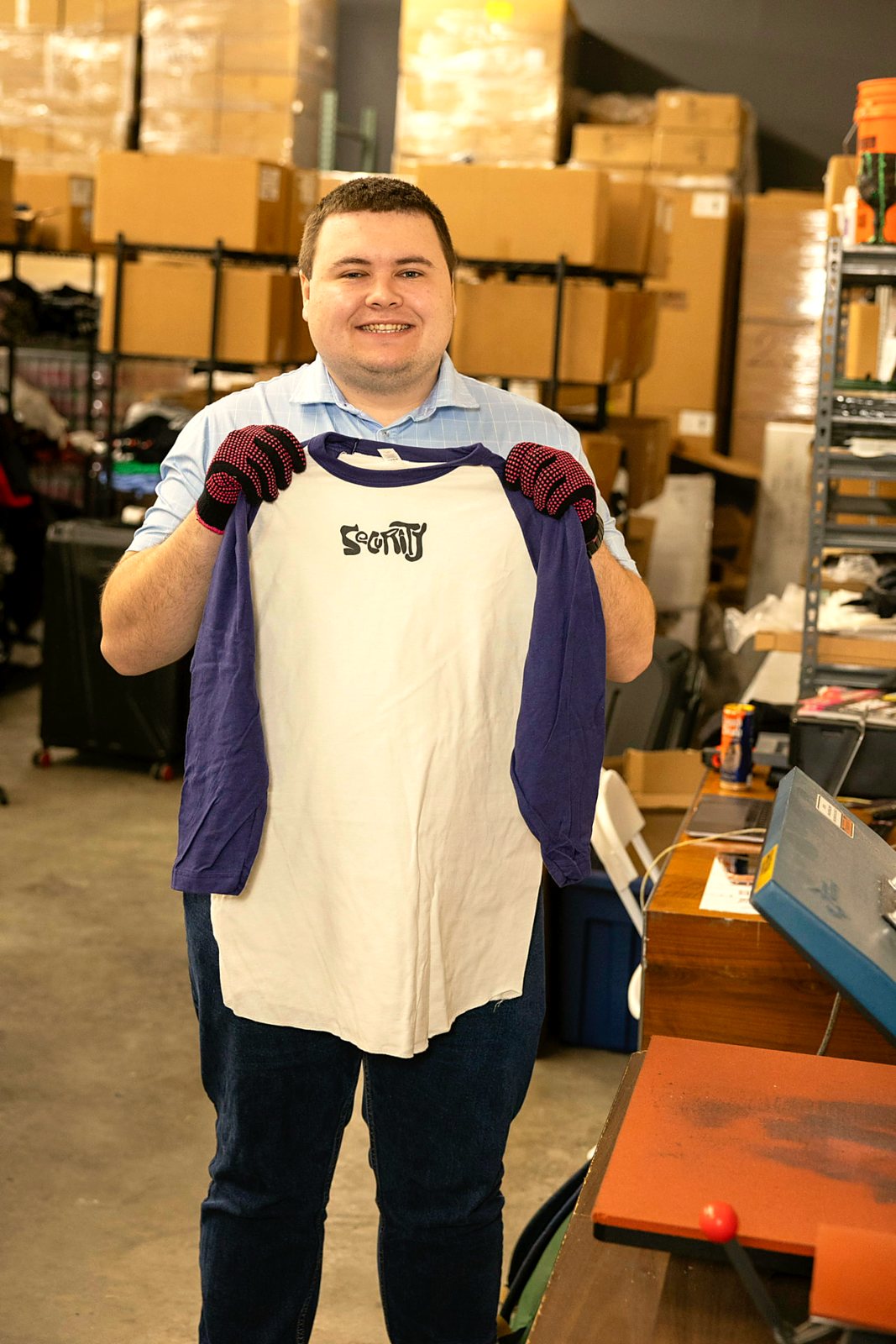 A participant checking a printed shirt in the production area