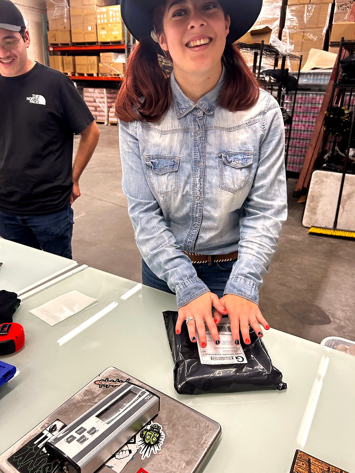 A participant checking finished pieces before an order is packed