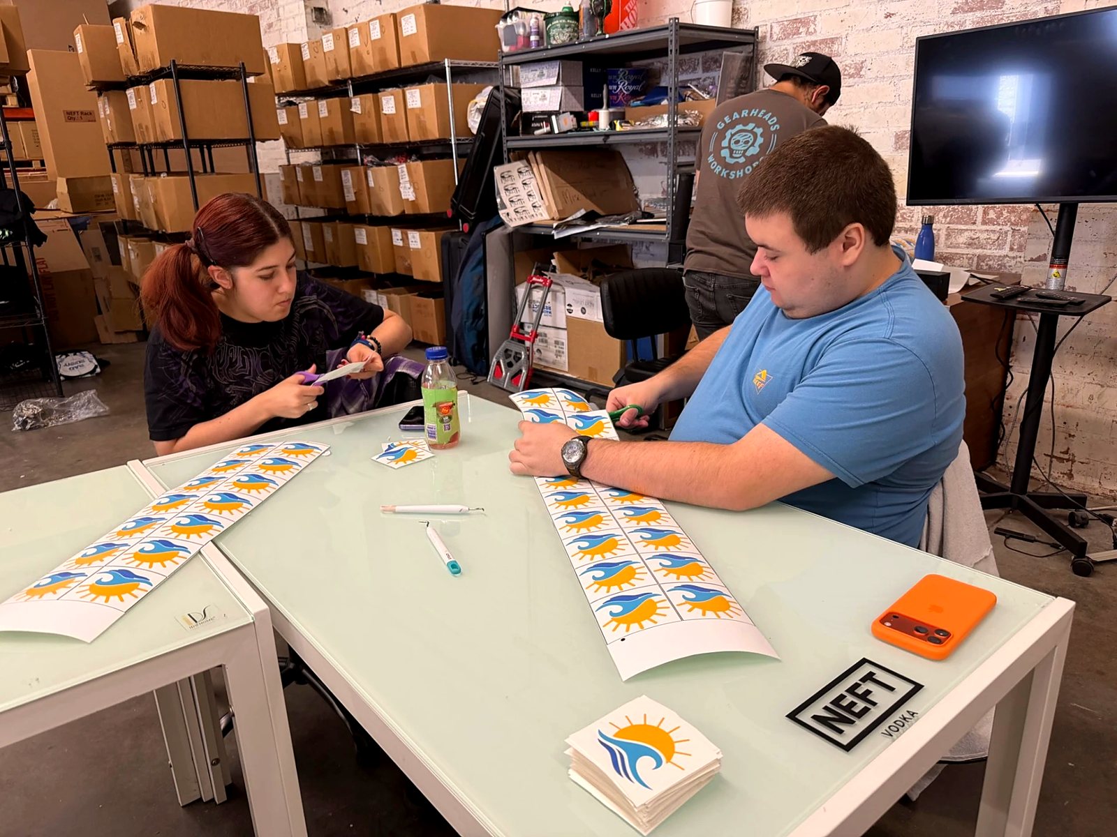 Participants sorting printed sheets together during a production day