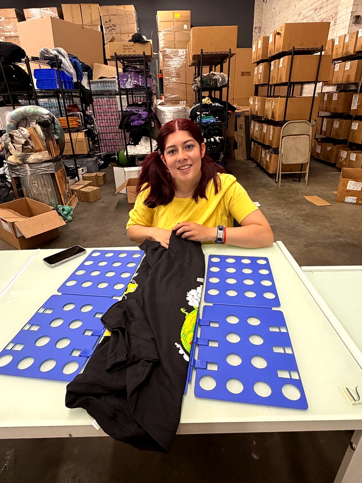 A team member reviewing prepared screens on the production table